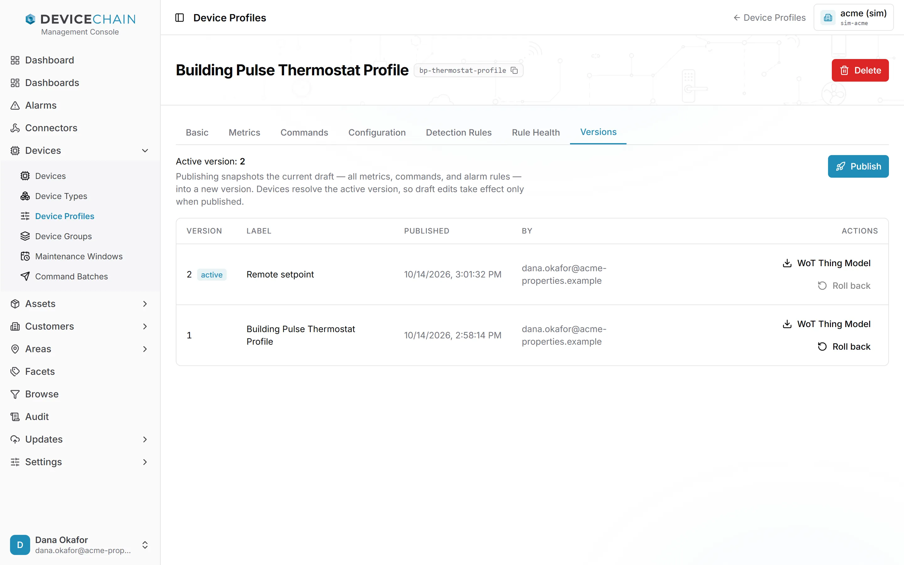 The Versions tab. It reads 'Active version: 2' and explains that publishing snapshots the current draft into a new version, and that devices resolve the active version. A Publish button is at the top right. A table with the columns Version, Label, Published, By and Actions lists version 2 (active, 'Remote setpoint') and version 1 ('Building Pulse Thermostat Profile'), both published by dana.okafor@acme-properties.example. Each row has a WoT Thing Model download button and a Roll back button; the active version's Roll back is greyed out.